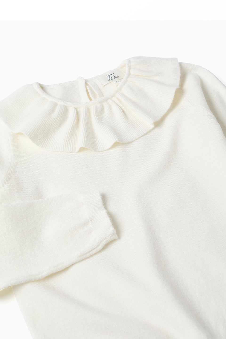 Jersey de punto con volante blanco niña